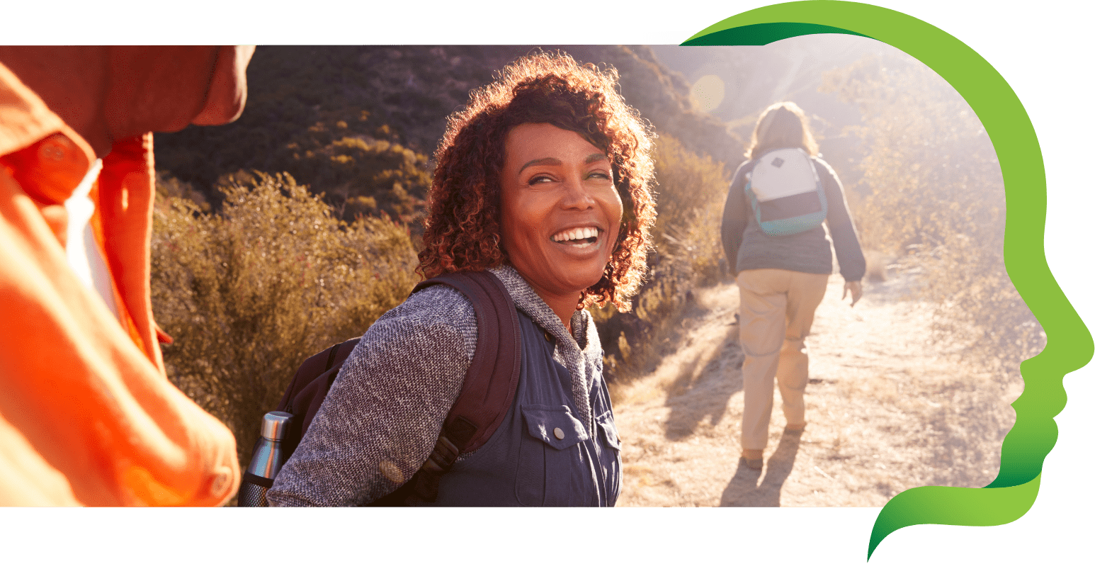 Woman smiles on a hiking trail